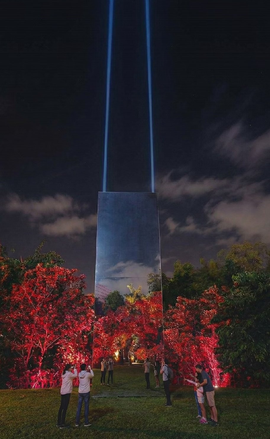 The Monolith at night — twin light beams reaching the sky